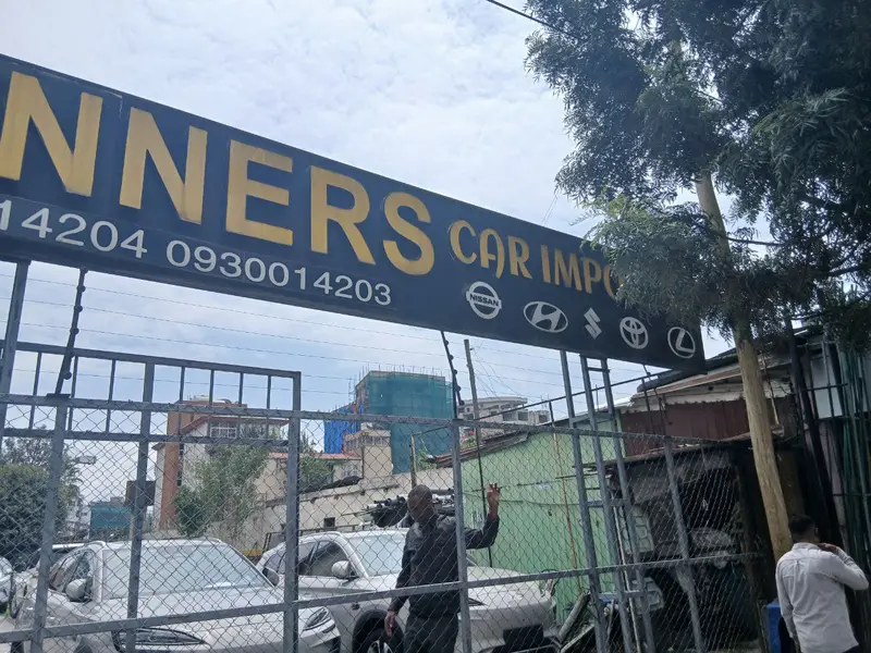 Winners sign and the gate to the car lot